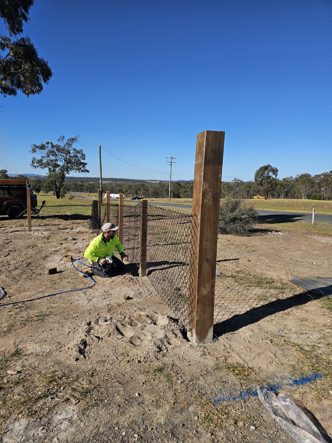 Timber post and wire fencing under construction