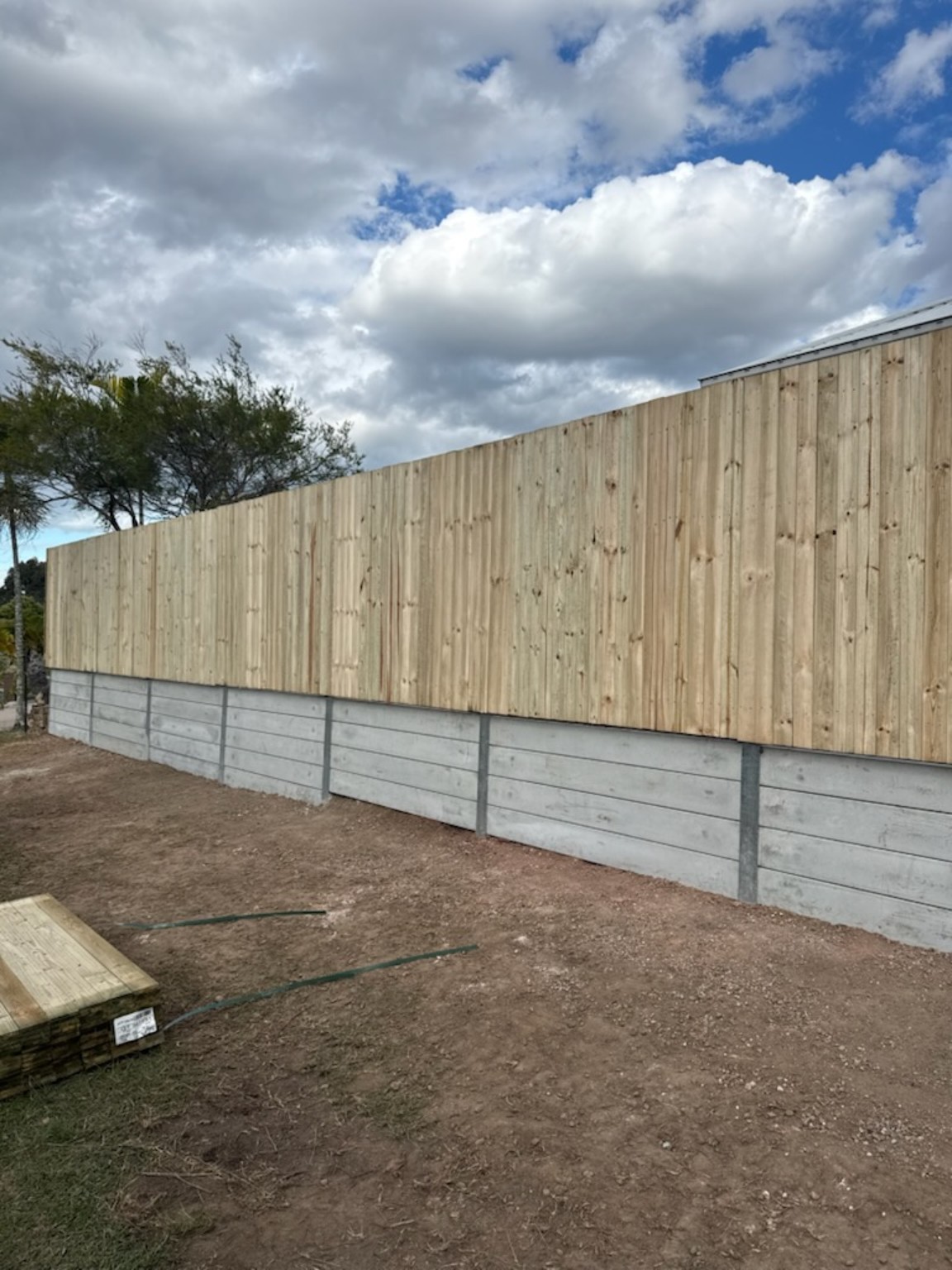 Completed concrete sleeper retaining wall and timber privacy fence